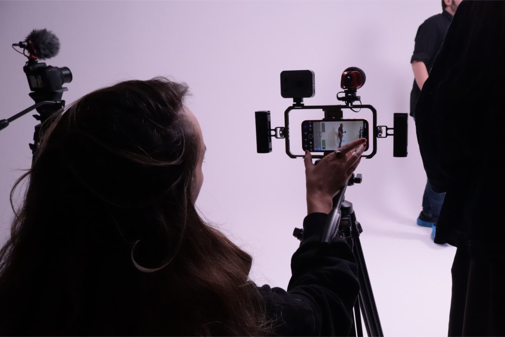 An educator filming with a smartphone rig