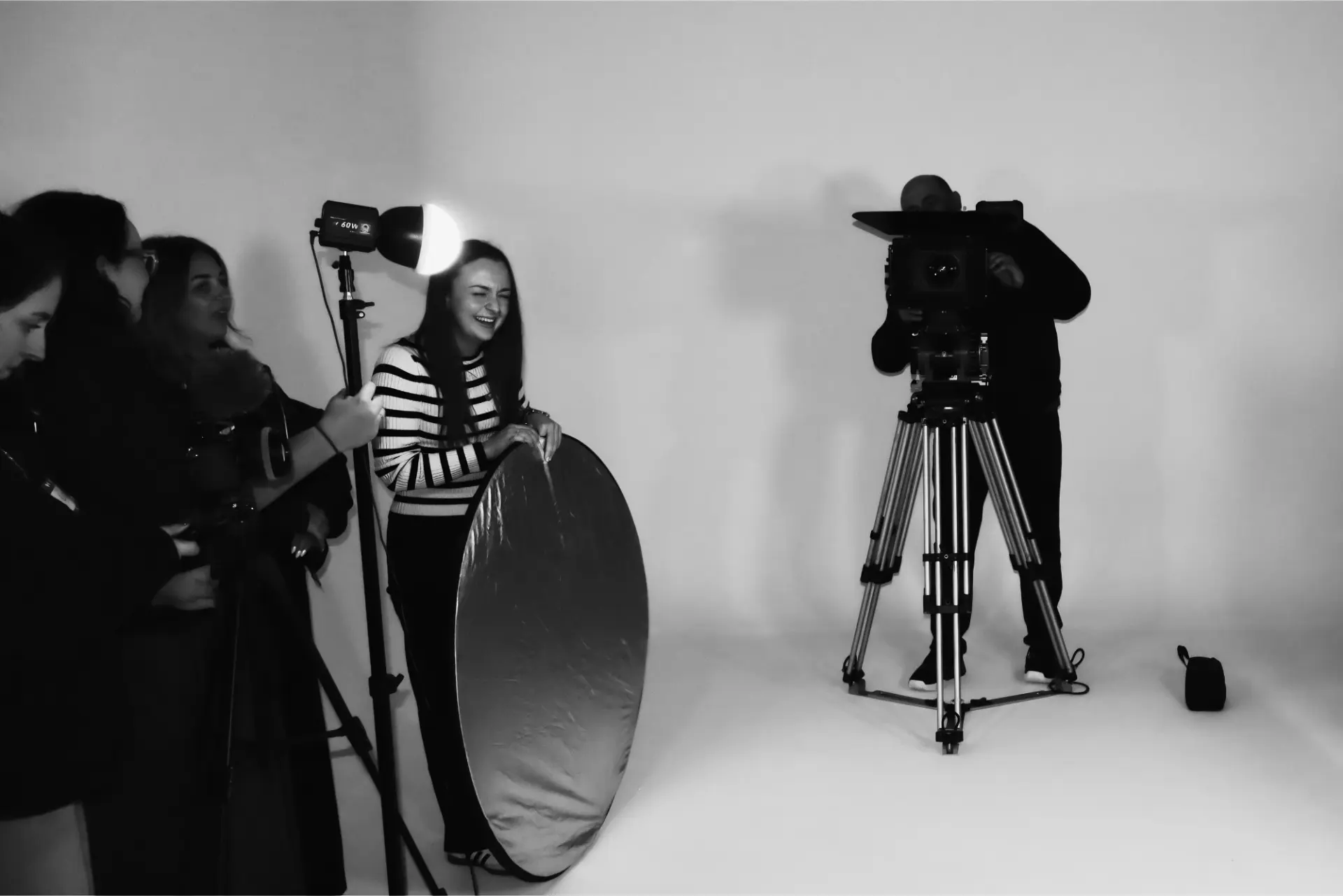 Educators working with camera and lighting kit in a studio
