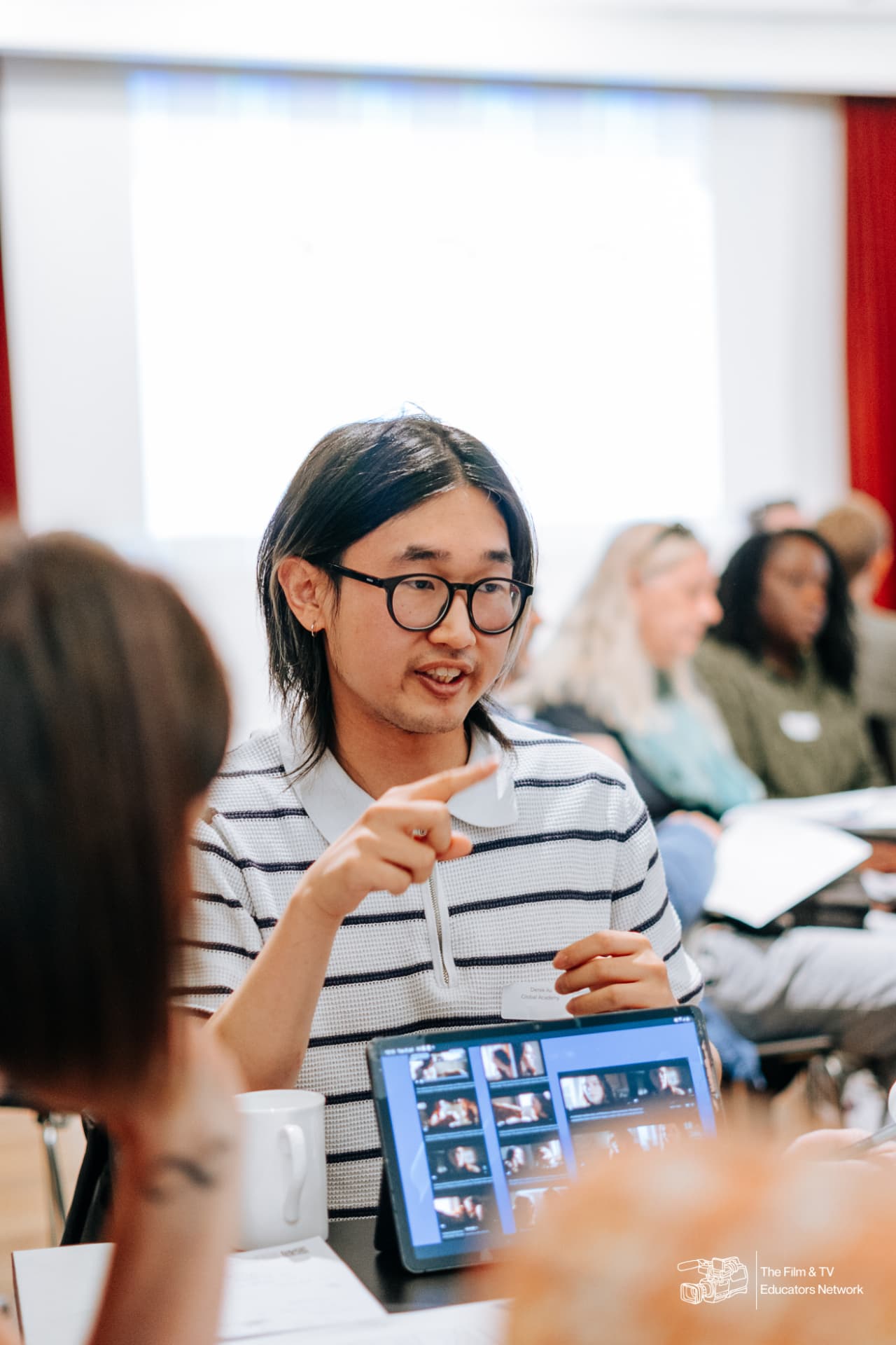An educator smiling during a hands-on session