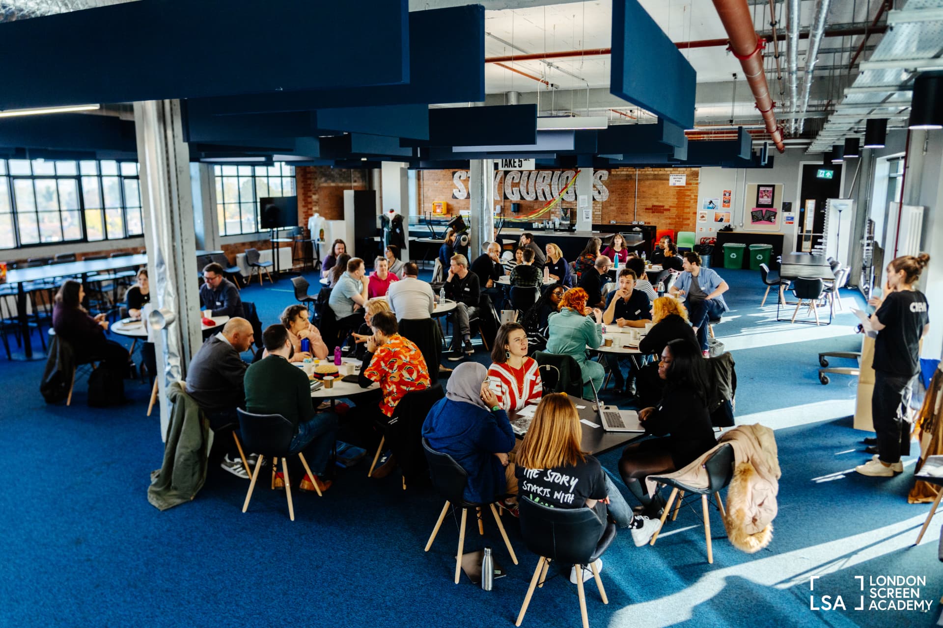 A large room of educators networking at an FTVEN event