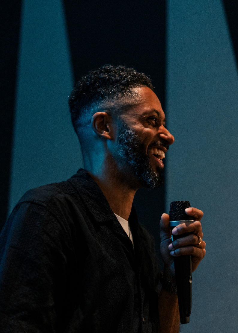 A speaker with a microphone addressing educators